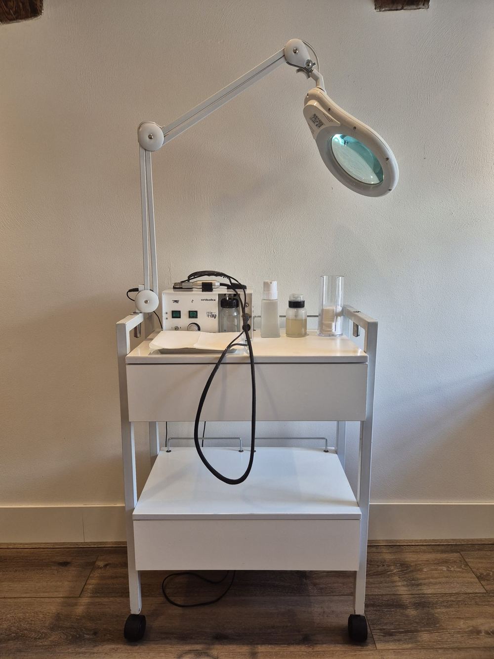 Het instrumentenkarretje met loeplamp en pedicureapparatuur